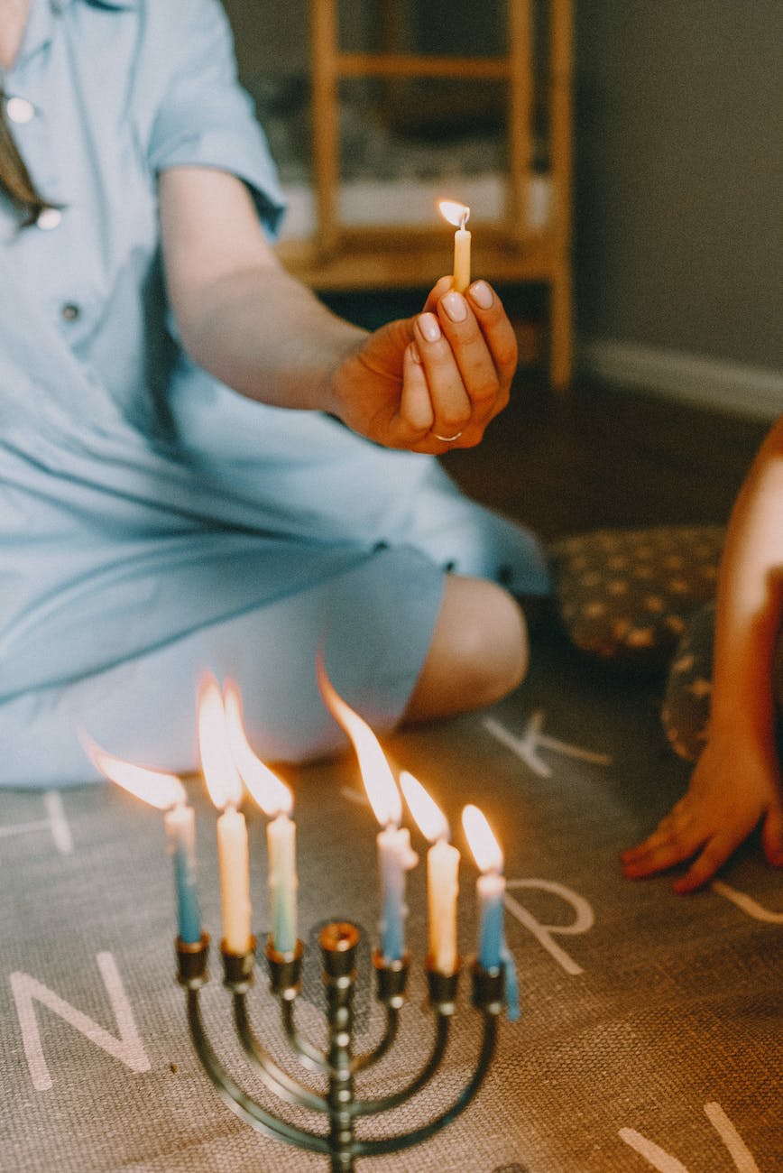 person lighting menorah